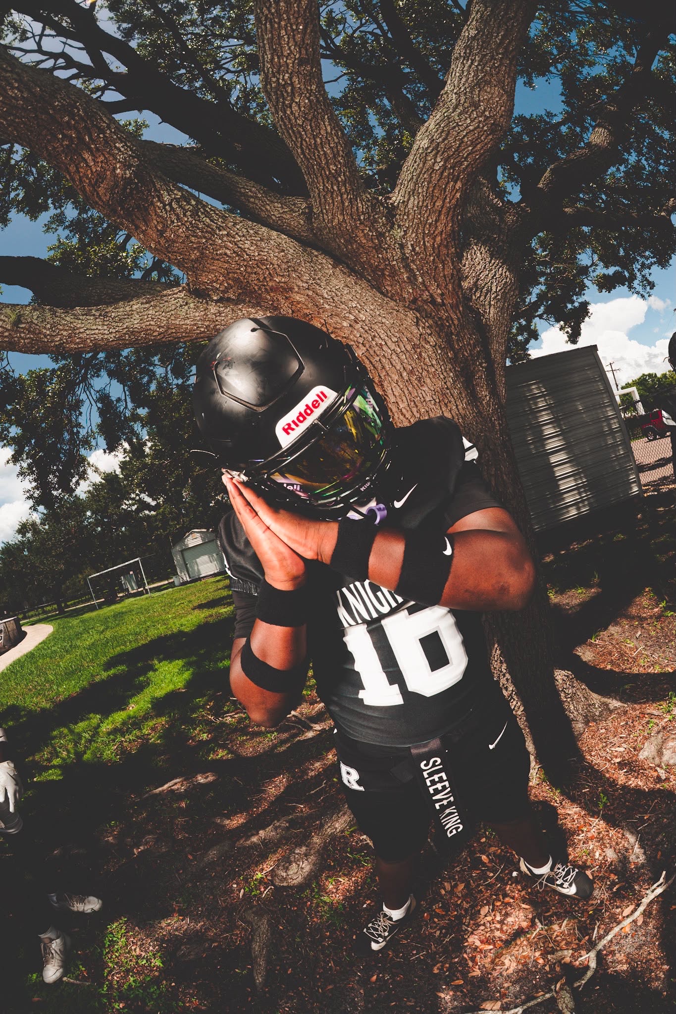 Daijon Johnson posing in his football uniform and helmet