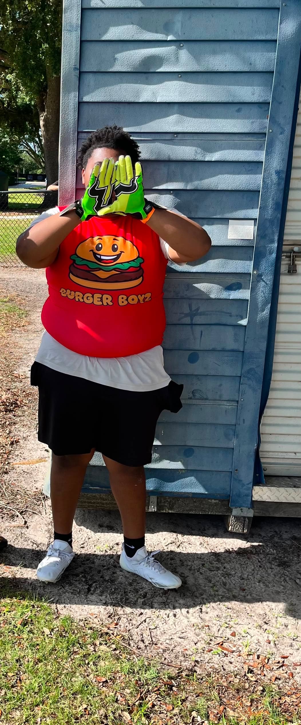 Jeremiah Watkins wearing his Burger Boyz uniform and football gloves